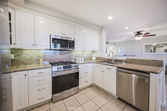 a view of a kitchen with living room and windows