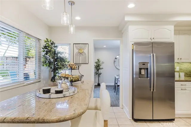a kitchen with stainless steel appliances granite countertop a refrigerator and a sink