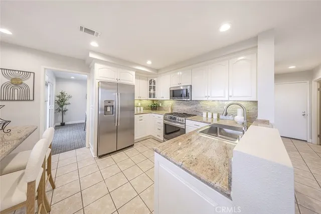 a view of a dining room with furniture and a chandelier