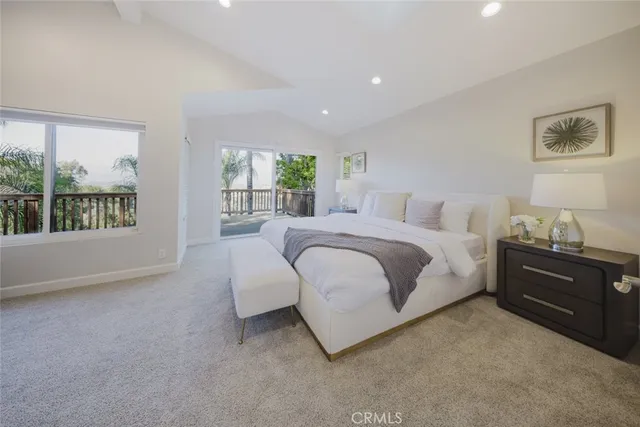 a bedroom with a large bed and a large window