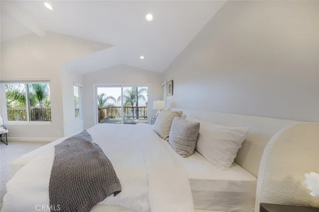 a spacious bedroom with a bed and a large window