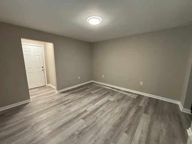 a view of an empty room and wooden floor