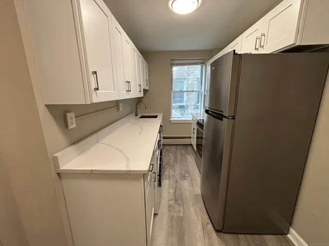a kitchen with refrigerator and window