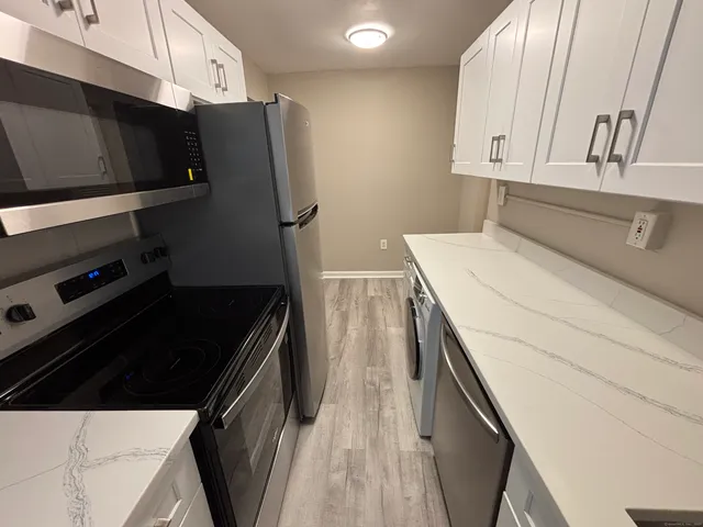 a kitchen with a refrigerator and a stove