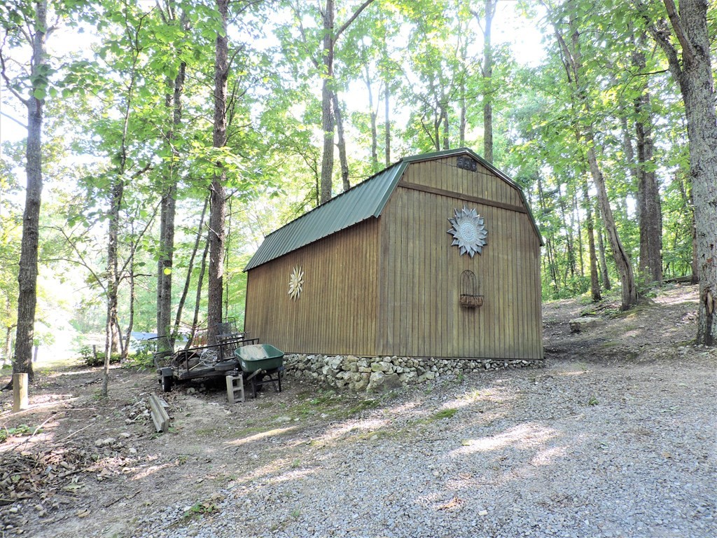 253 Wilder Road Spring City, TN 37381 - Photo 3 of 18 a backyard of a house with table and chairs