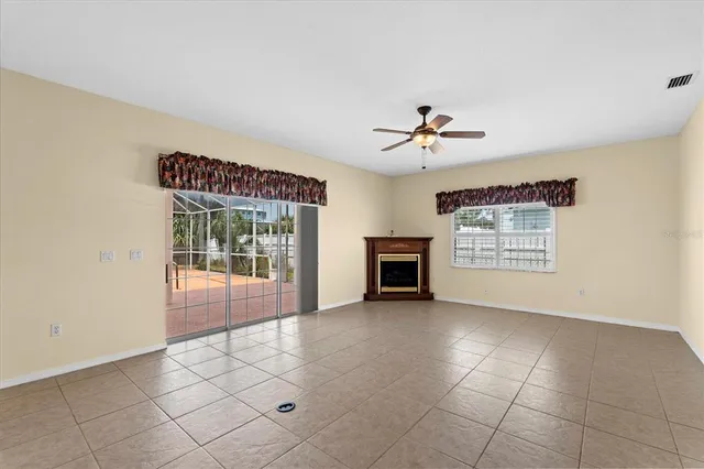 a view of empty room with a fireplace