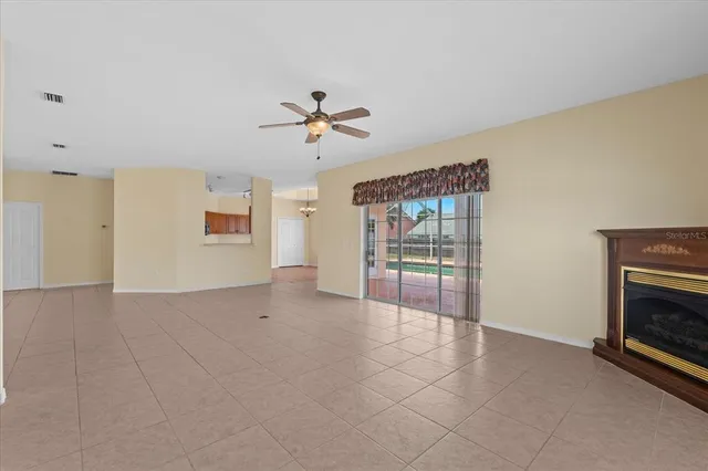 a view of an empty room with a ceiling fan