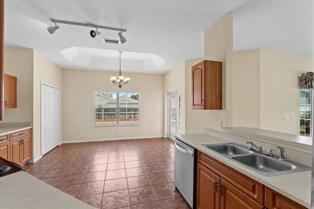 a kitchen with stainless steel appliances granite countertop a stove top oven a sink and dishwasher
