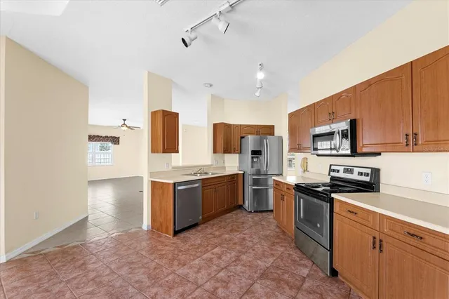 a kitchen with stainless steel appliances granite countertop a refrigerator sink and cabinets