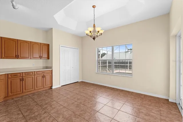 a large kitchen with kitchen island a large counter top space stainless steel appliances and cabinets