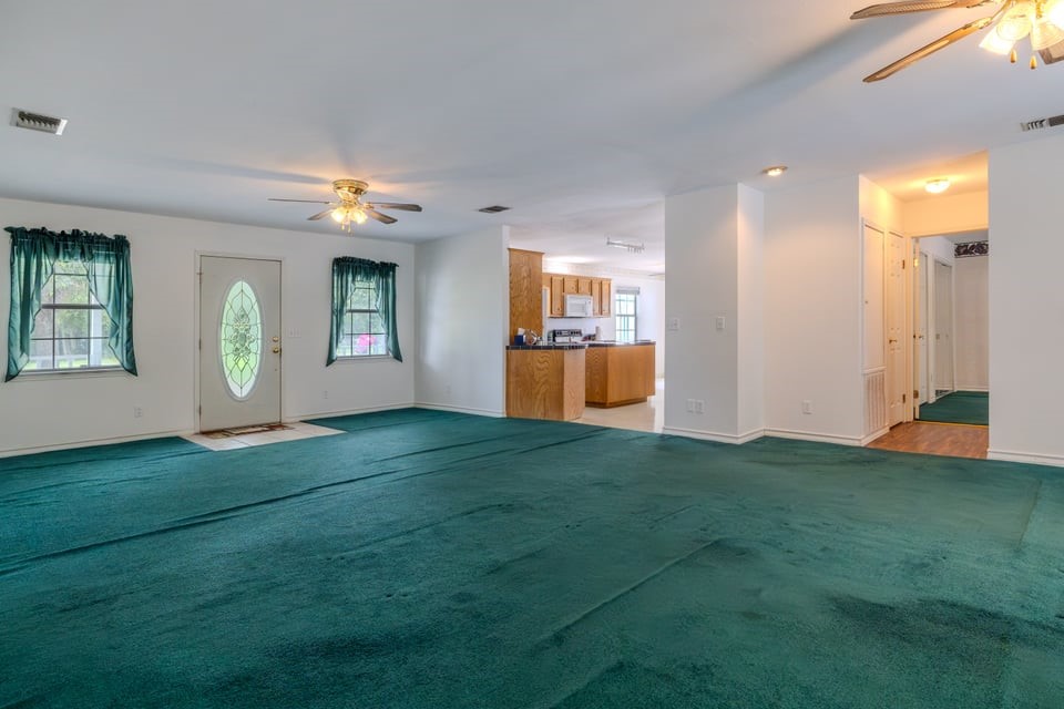 483 Riverside Drive Palacios, TX 77465 - Photo 14 of 41 a view of livingroom with hardwood floor and kitchen view