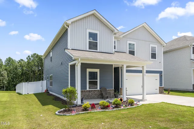 a front view of house with yard outdoor seating and garage