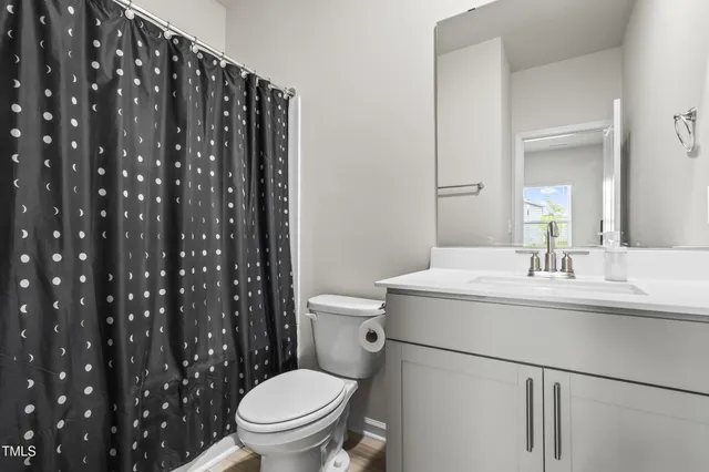 a kitchen with sink and view of living room