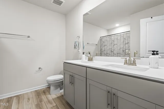 a view of a walk in closet and bathroom