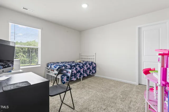 a bedroom with furniture and a window