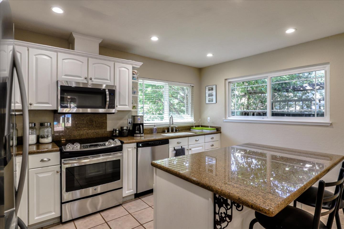 470 Corte Cabanil Morgan Hill, CA 95037 - Photo 8 of 22 a kitchen with granite countertop a stove sink and microwave