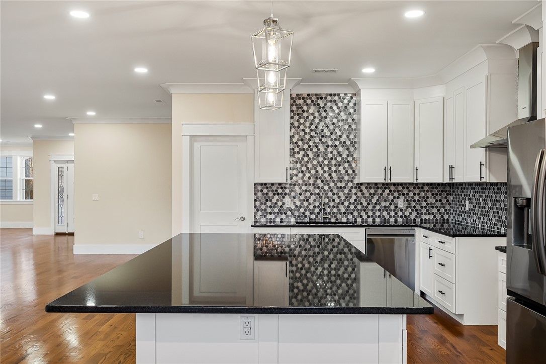 303 Regency Circle Anderson, SC 29625 - Photo 10 of 50 This kitchen features a spacious island with sleek countertops, complemented by modern appliances.