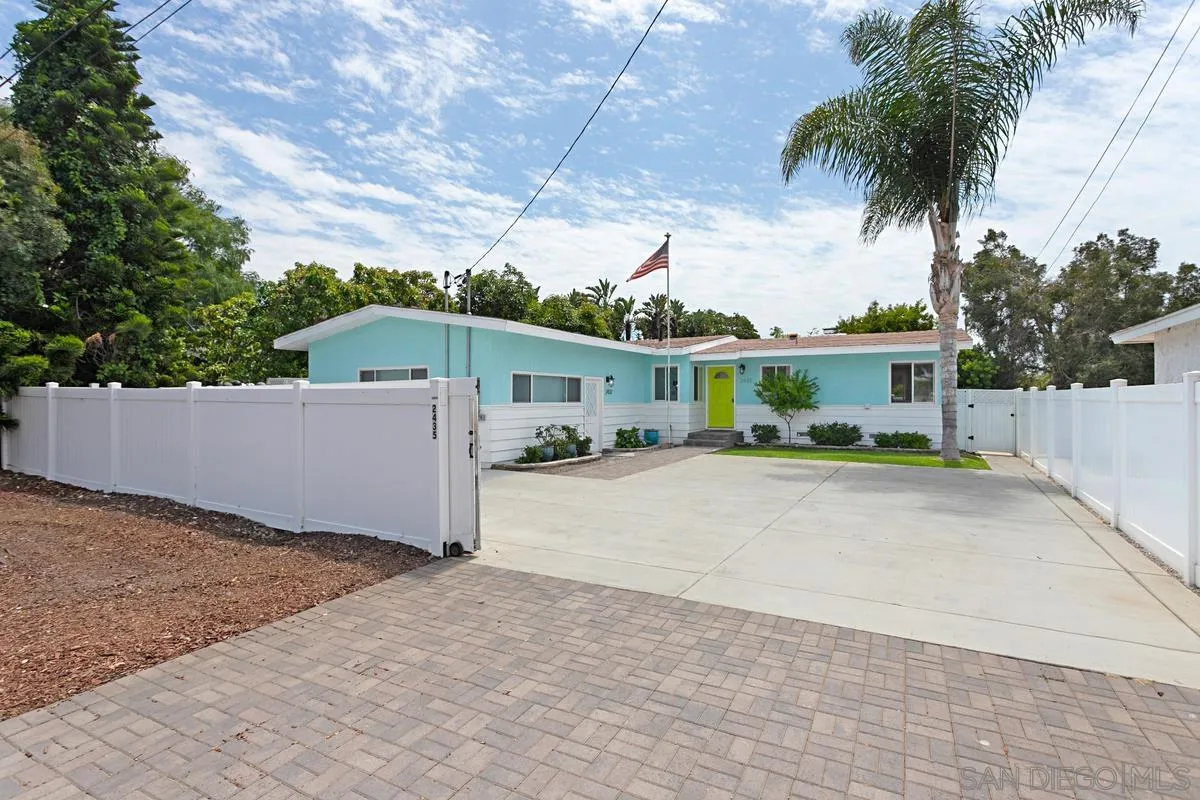 2435 Tuttle Street Carlsbad, CA 92008 - Photo 1 of 38 a front view of a house with a yard and garage