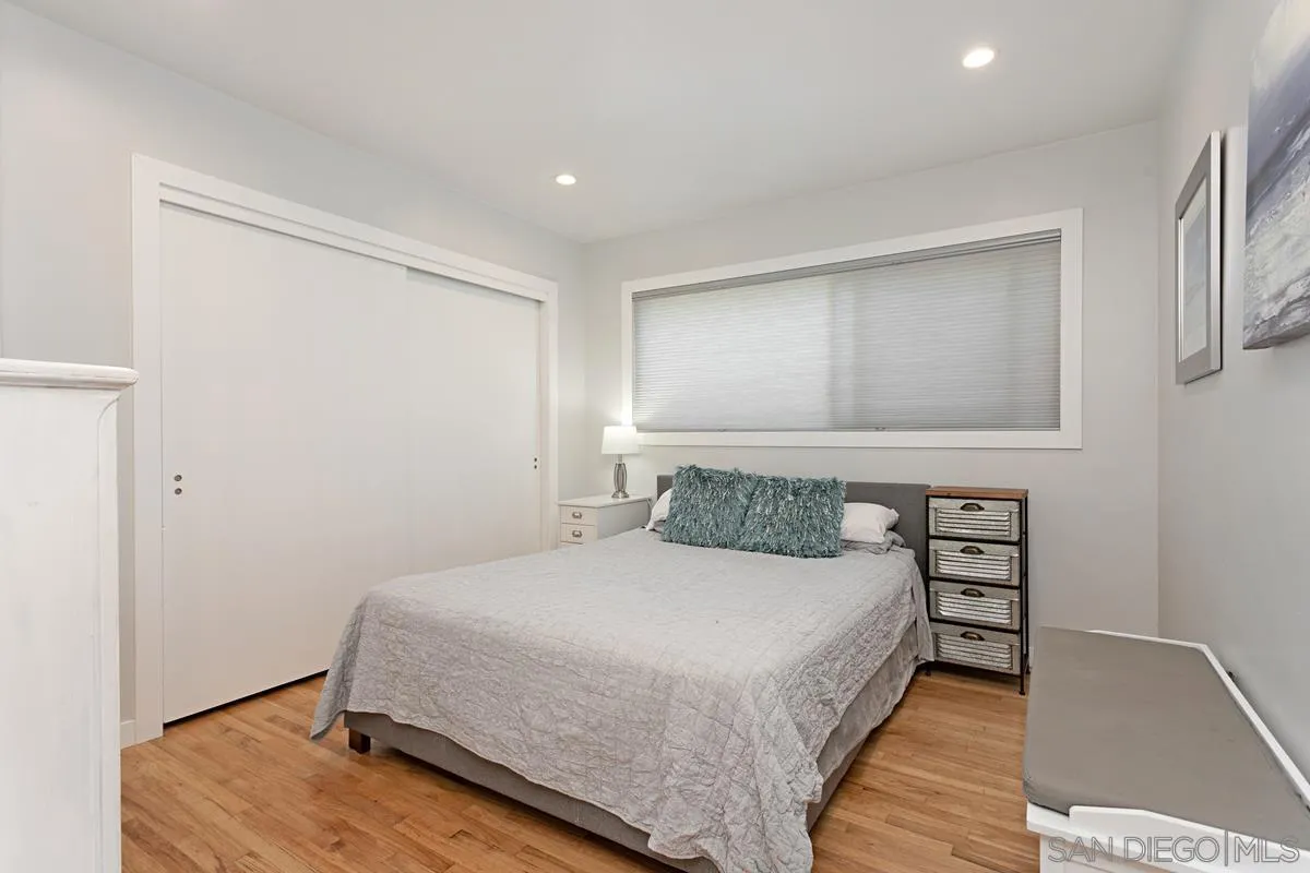 2435 Tuttle Street Carlsbad, CA 92008 - Photo 25 of 38 a bedroom with a bed and wooden floor