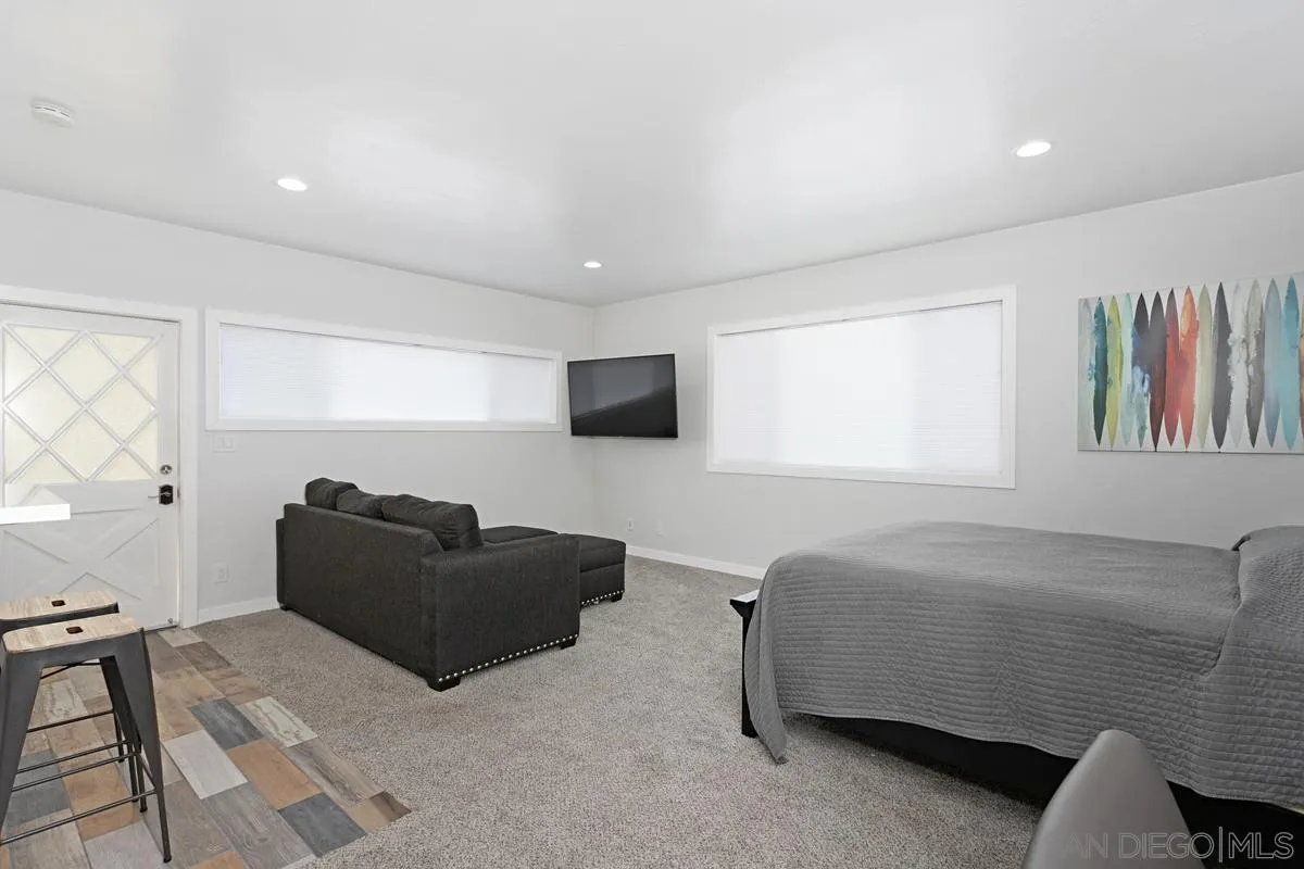 2435 Tuttle Street Carlsbad, CA 92008 - Photo 33 of 38 a living room with furniture and a flat screen tv