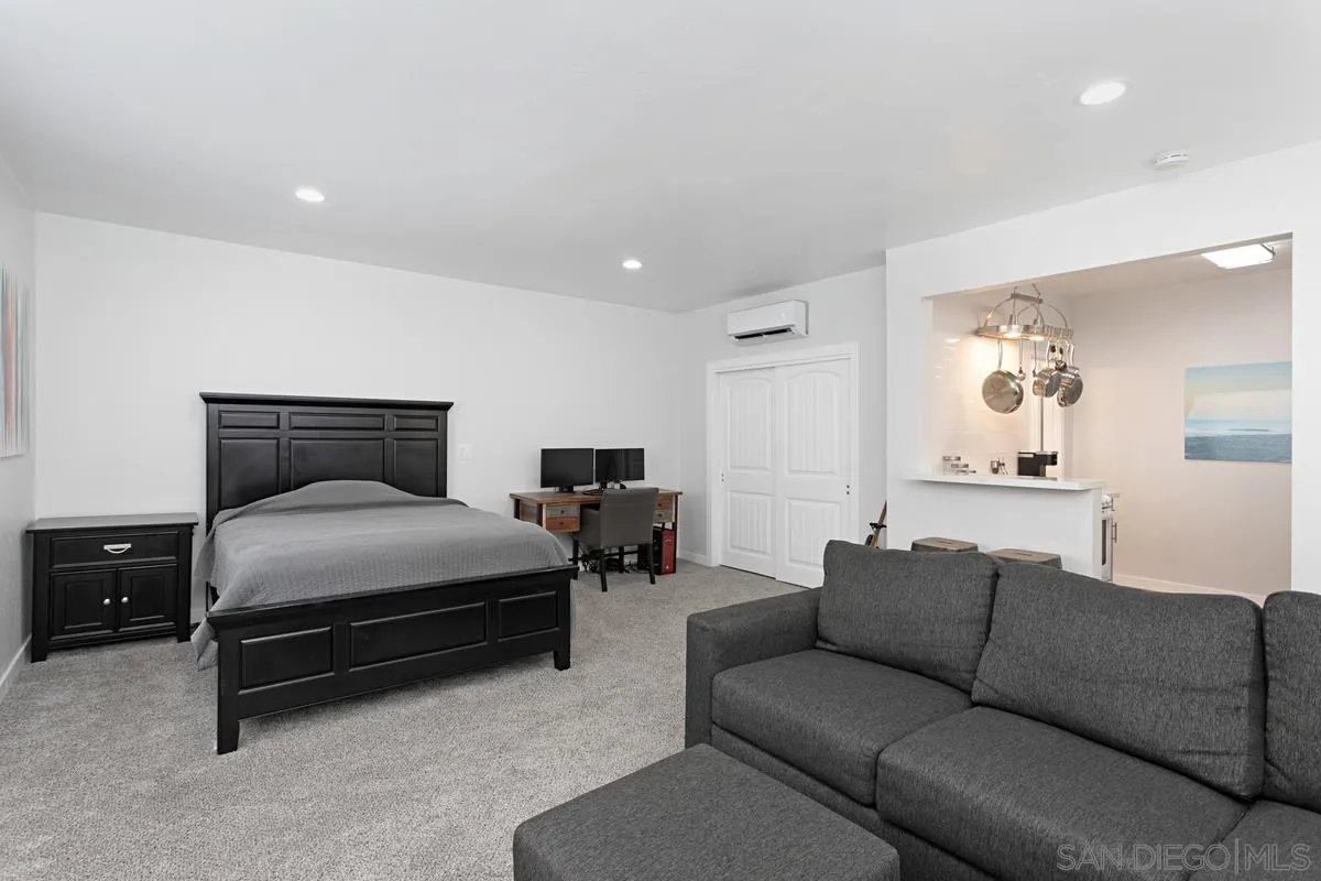 2435 Tuttle Street Carlsbad, CA 92008 - Photo 35 of 38 a spacious bedroom with a bed and a couch