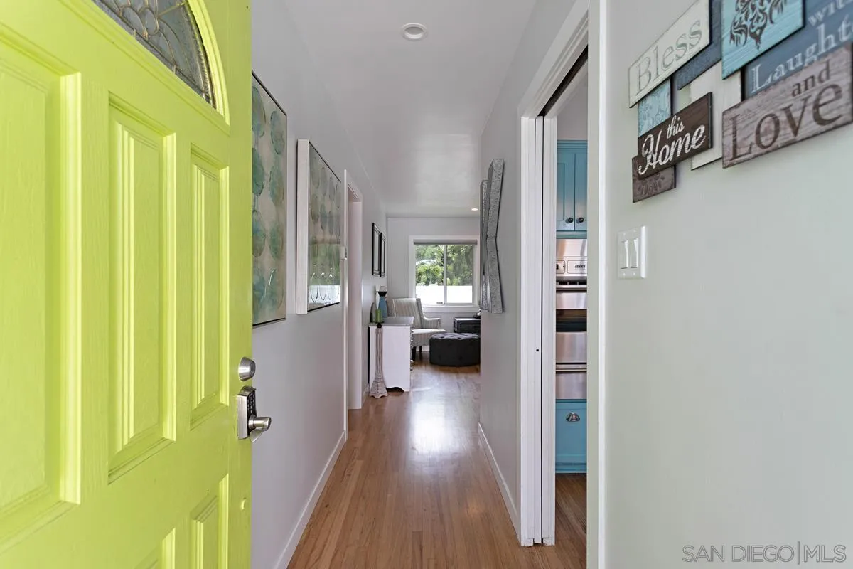 2435 Tuttle Street Carlsbad, CA 92008 - Photo 5 of 38 a view of a hallway with wooden floor