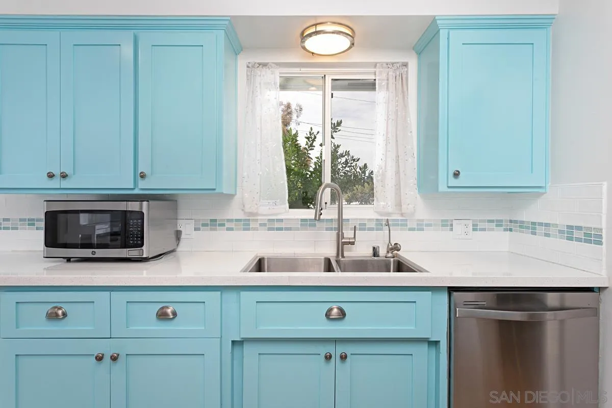 2435 Tuttle Street Carlsbad, CA 92008 - Photo 10 of 38 a kitchen with a sink and a microwave