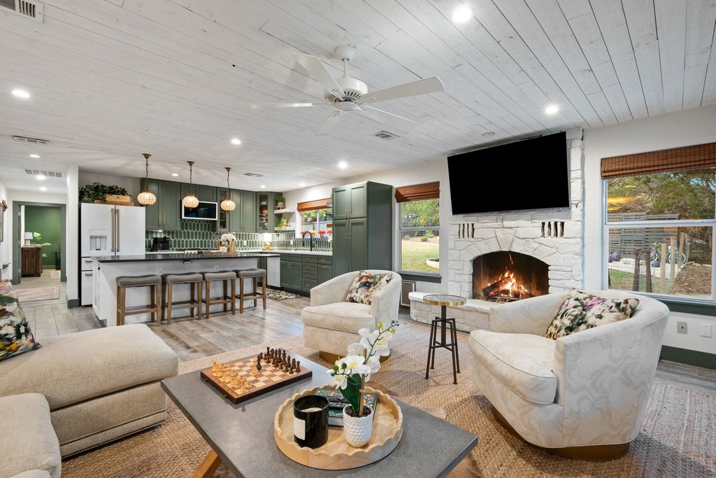Living area with wooden ceiling, a ceiling fan, light wood-style flooring, recessed lighting, and a fireplace