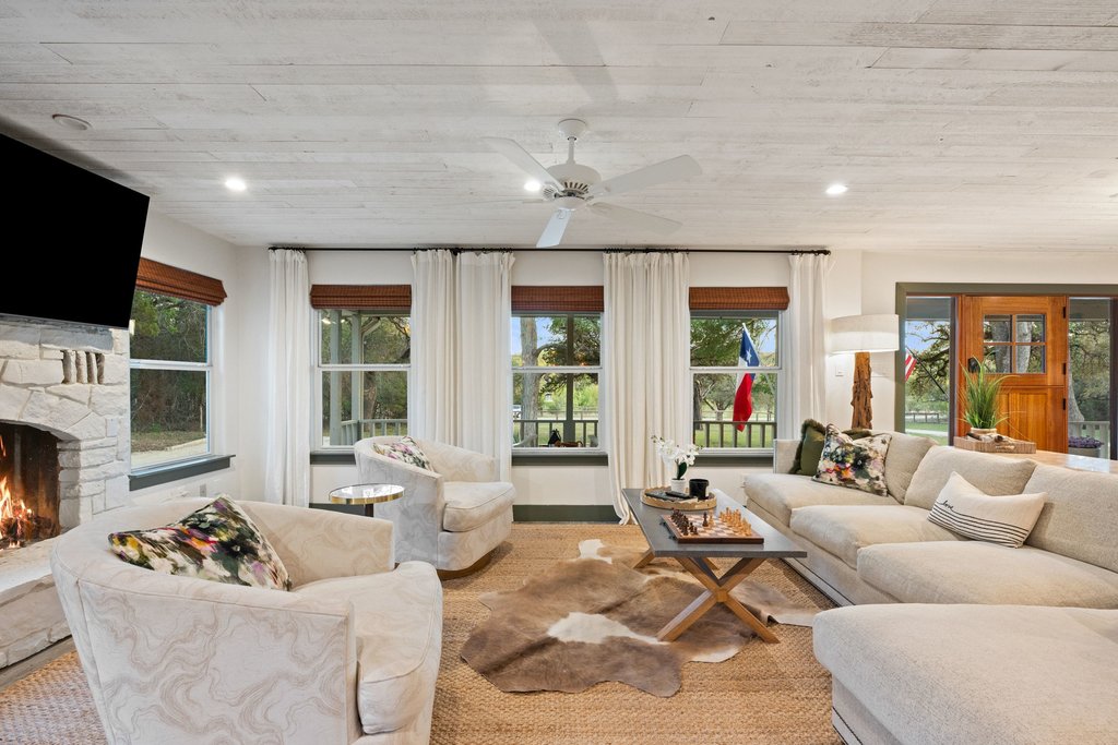 2800 River Road Wimberley, TX 78676 - Photo 12 of 38 Living area featuring a ceiling fan, a fireplace, healthy amount of natural light, and recessed lighting