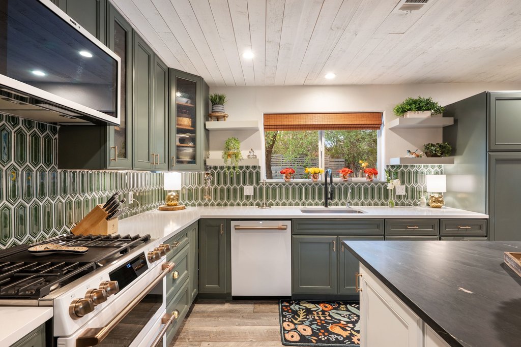 2800 River Road Wimberley, TX 78676 - Photo 13 of 38 Remodeled kitchen featuring white cafe appliances, open shelves, range hood, dark stone countertops, and wooden ceiling