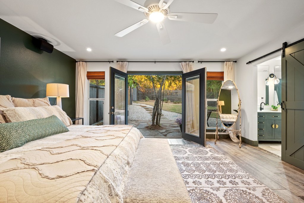 2800 River Road Wimberley, TX 78676 - Photo 17 of 38 Bedroom featuring a barn door, light wood-style flooring, recessed lighting, a ceiling fan, and access to outside