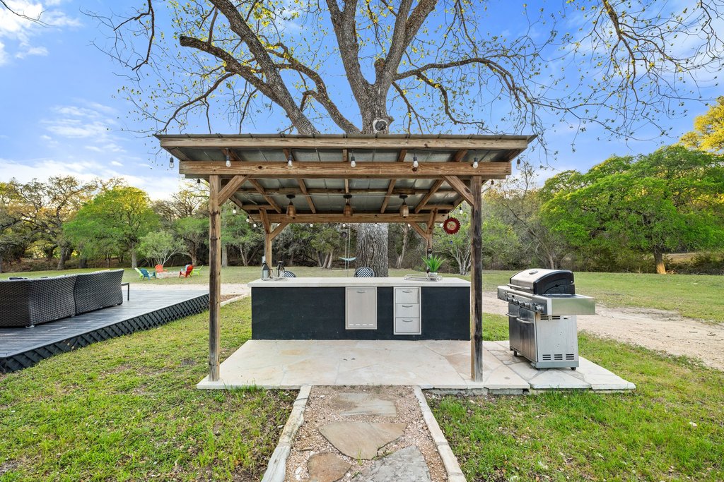 2800 River Road Wimberley, TX 78676 - Photo 26 of 40 View of patio featuring area for grilling and view of scattered trees