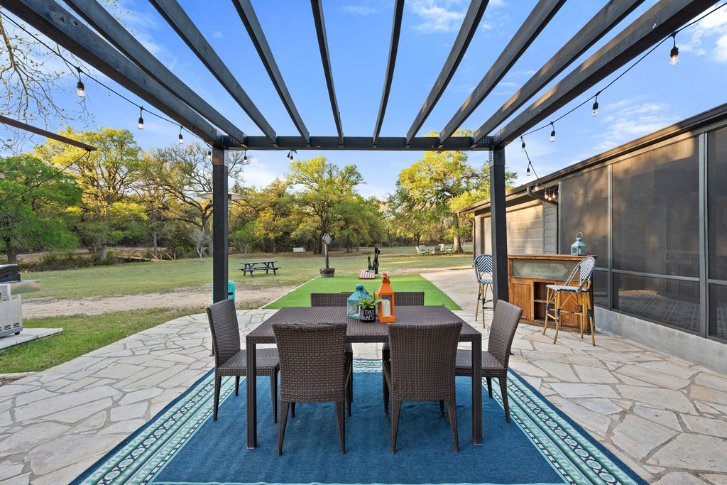 2800 River Road Wimberley, TX 78676 - Photo 26 of 38 View of patio / terrace featuring a pergola and an outdoor bar and dining area