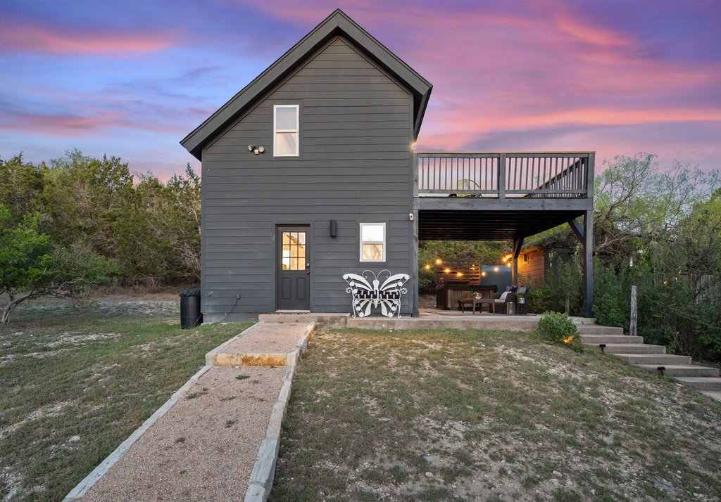 2800 River Road Wimberley, TX 78676 - Photo 29 of 40 Back of property at dusk with a patio, a lawn, and a wooden deck