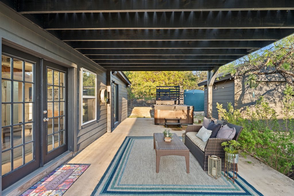 2800 River Road Wimberley, TX 78676 - Photo 33 of 40 View of patio / terrace featuring a hot tub, french doors, and an outdoor living space