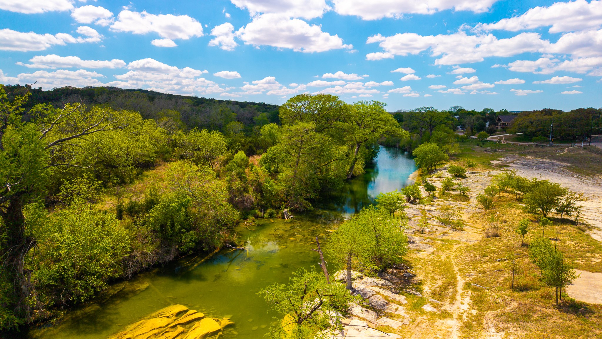 2800 River Road Wimberley, TX 78676 - Photo 37 of 40 Aerial view of a nearby body of water and a tree filled landscape