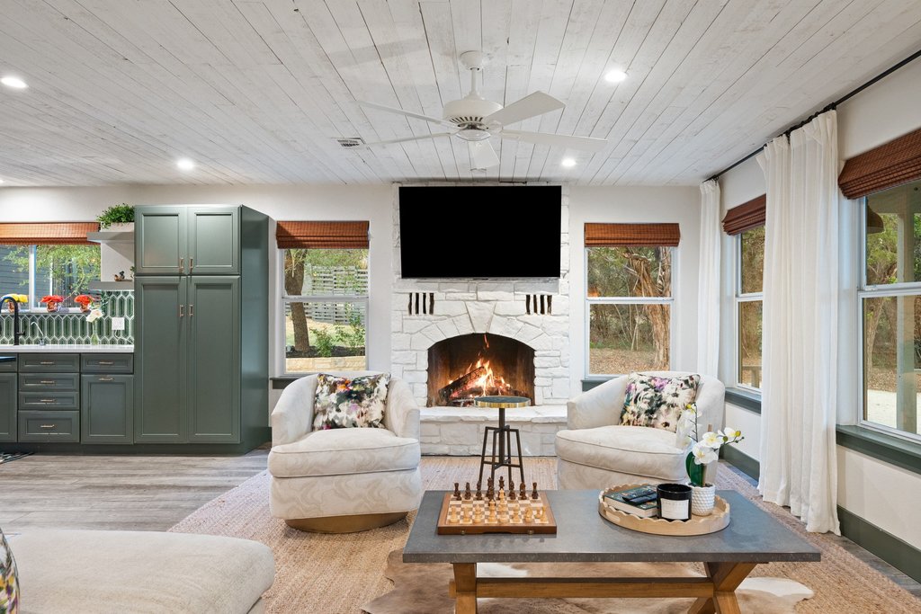 2800 River Road Wimberley, TX 78676 - Photo 7 of 40 Living area with ceiling fan, wood ceiling, a fireplace, light wood-style floors, and recessed lighting