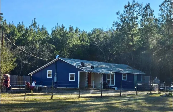 a front view of a house with a small pool