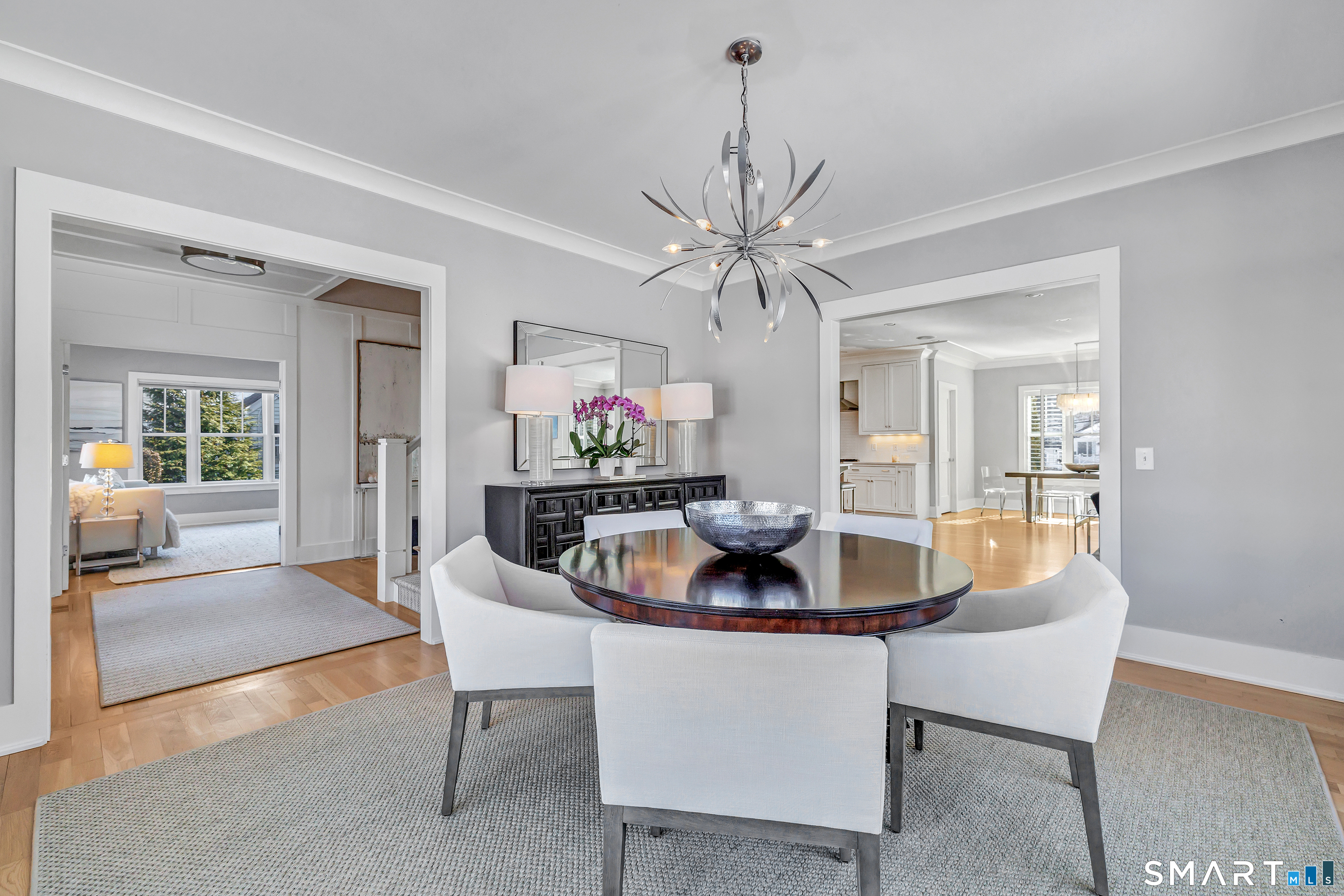 598 South Benson Road Fairfield, CT 06824 - Photo 14 of 40 a dining room with furniture a rug a potted plant and a chandelier