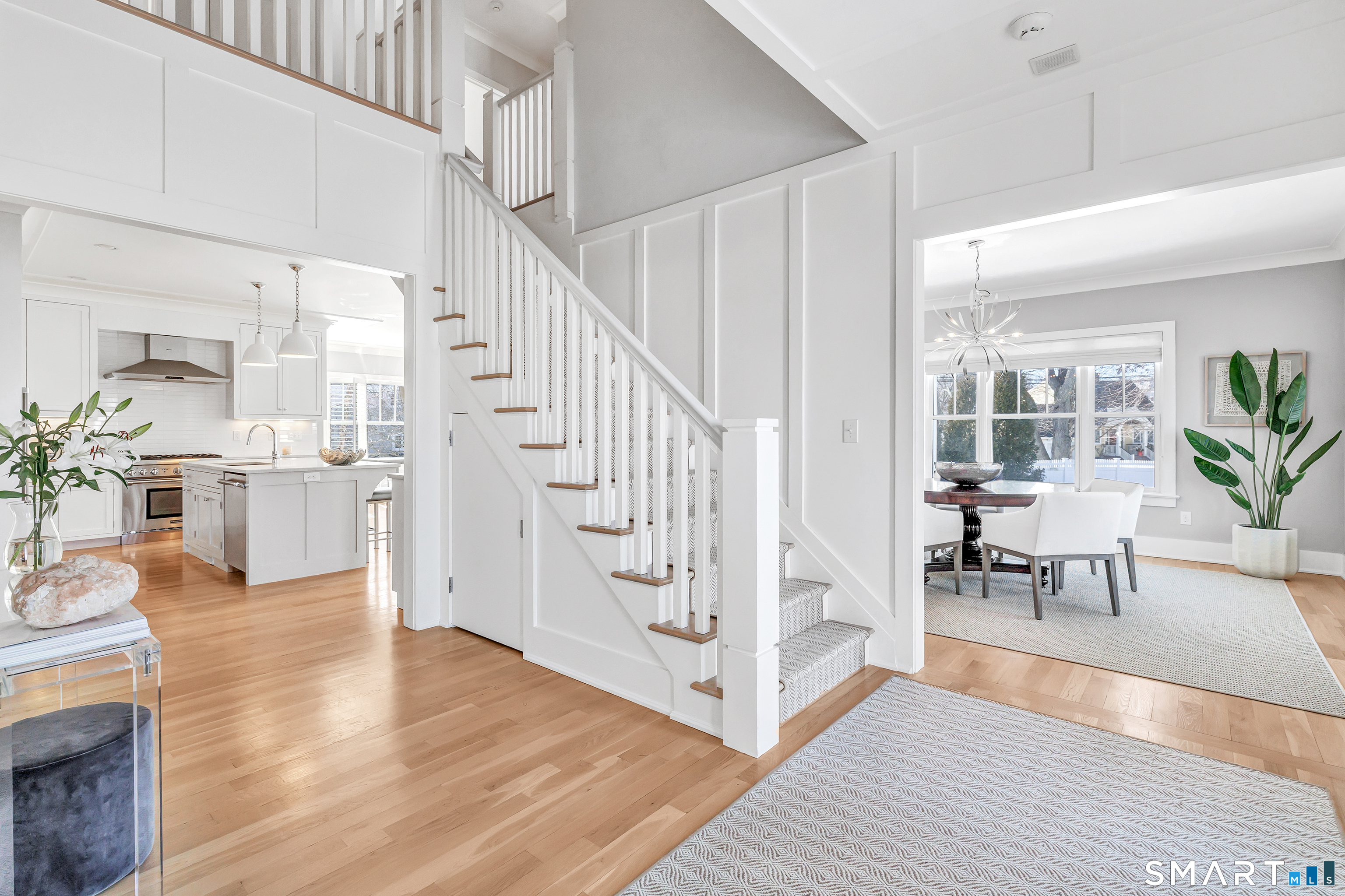 598 South Benson Road Fairfield, CT 06824 - Photo 17 of 40 a living room with furniture and a dining table with wooden floor