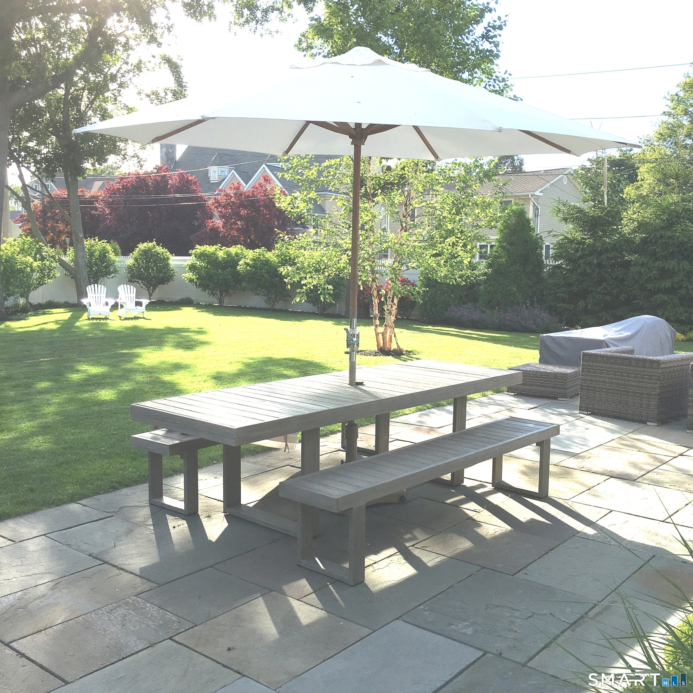 598 South Benson Road Fairfield, CT 06824 - Photo 38 of 40 a view of swimming pool with a table and chairs under an umbrella