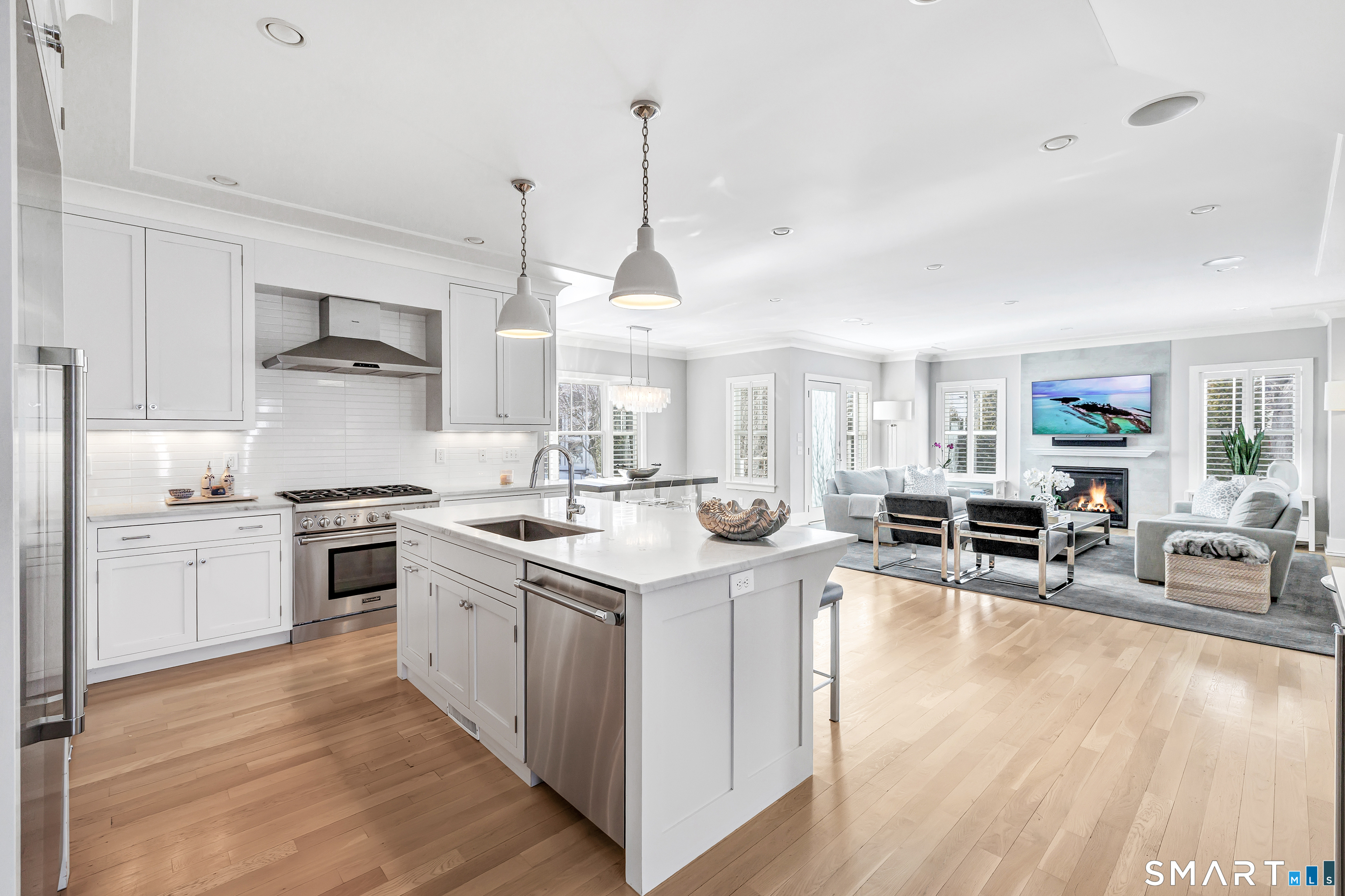 598 South Benson Road Fairfield, CT 06824 - Photo 4 of 40 a kitchen with stainless steel appliances granite countertop a stove oven and a view of living room