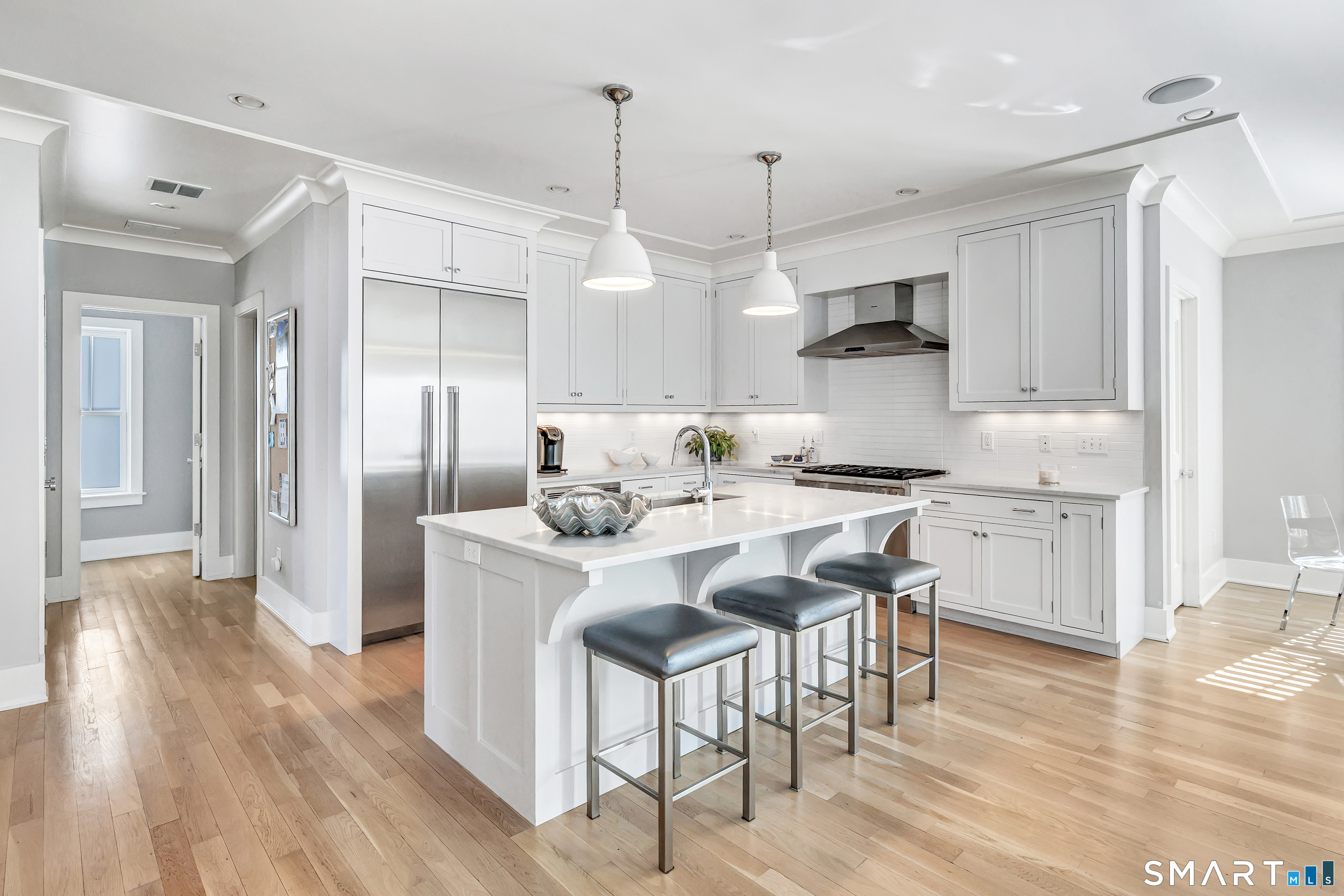 598 South Benson Road Fairfield, CT 06824 - Photo 5 of 40 a kitchen with stainless steel appliances kitchen island granite countertop a table chairs and a refrigerator