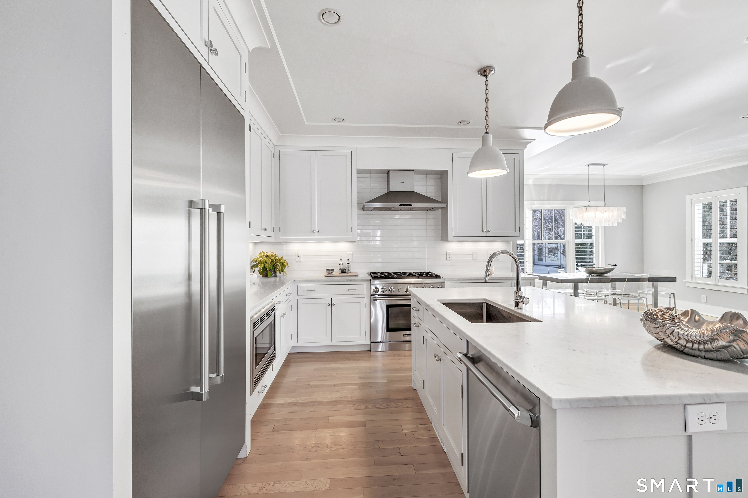 598 South Benson Road Fairfield, CT 06824 - Photo 7 of 40 a kitchen with white cabinets and stainless steel appliances