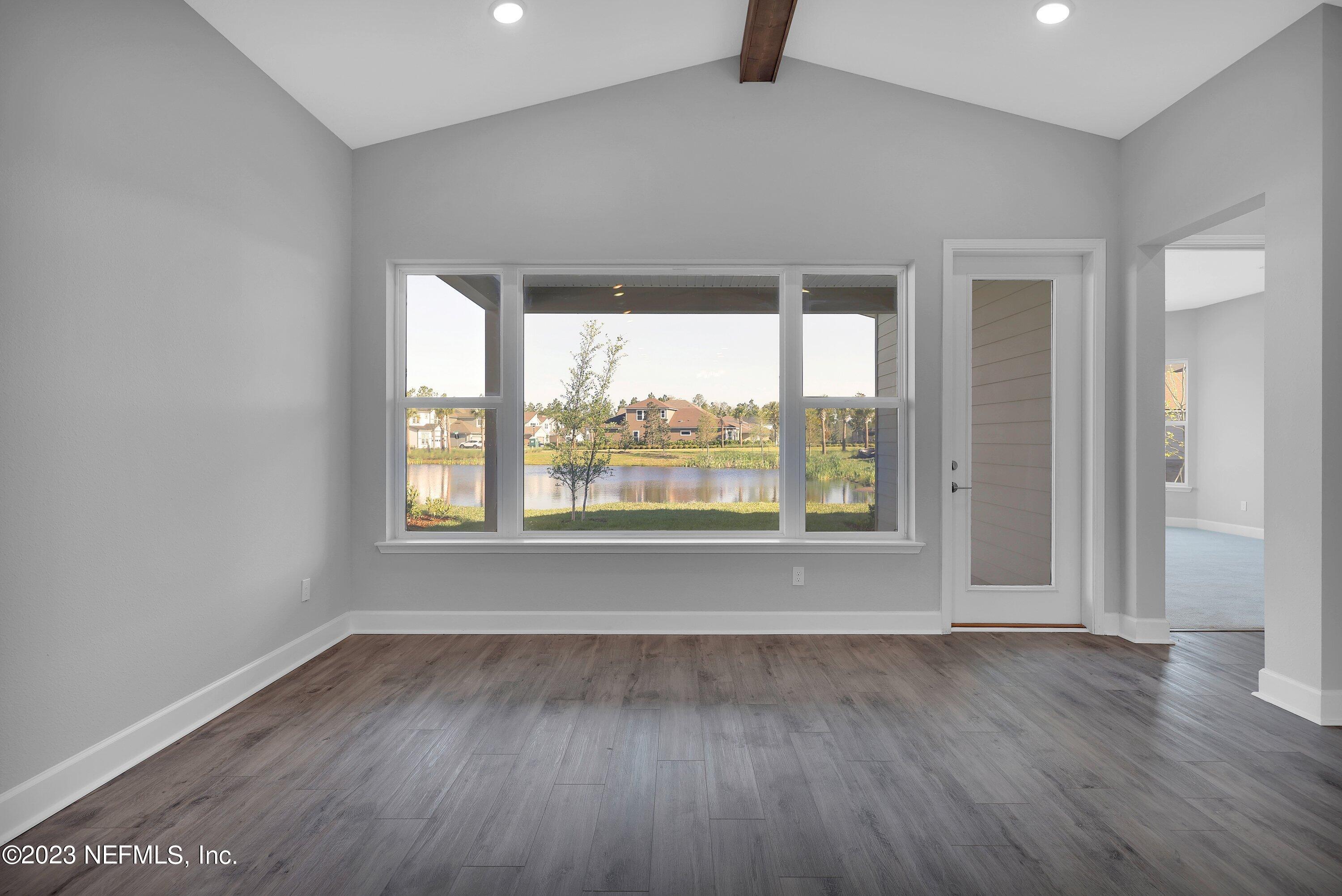 11243 Bright Path Jacksonville, FL 32256 - Photo 17 of 38 an empty room with wooden floor and windows
