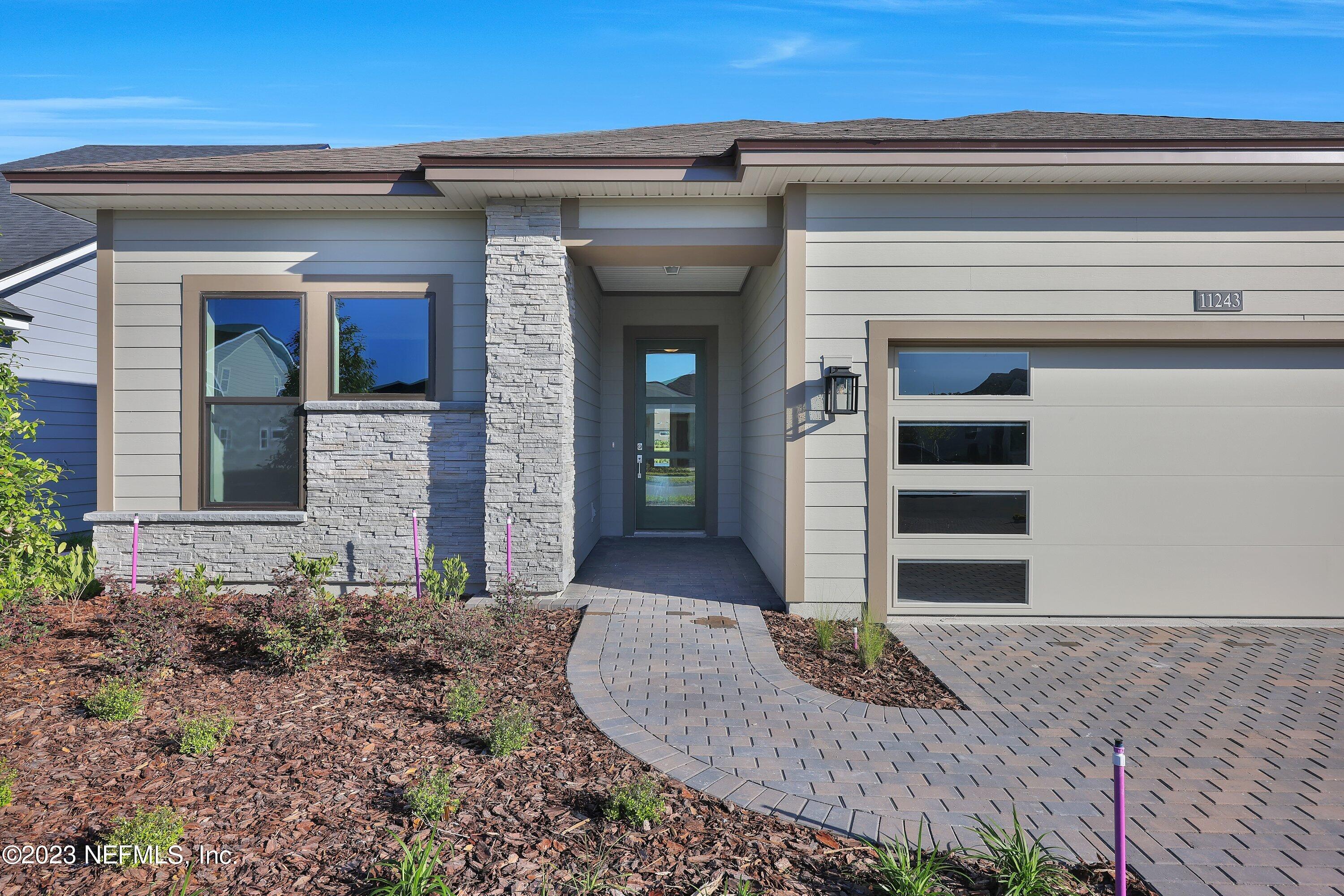 11243 Bright Path Jacksonville, FL 32256 - Photo 4 of 38 a front view of a house with garden