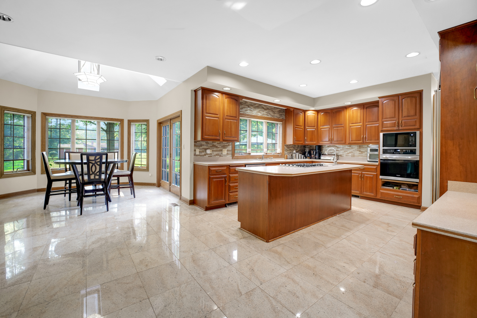 1816 Princeton Road Flossmoor, IL 60422 - Photo 4 of 26 a kitchen with stainless steel appliances granite countertop a stove top oven a sink a dining table and chairs
