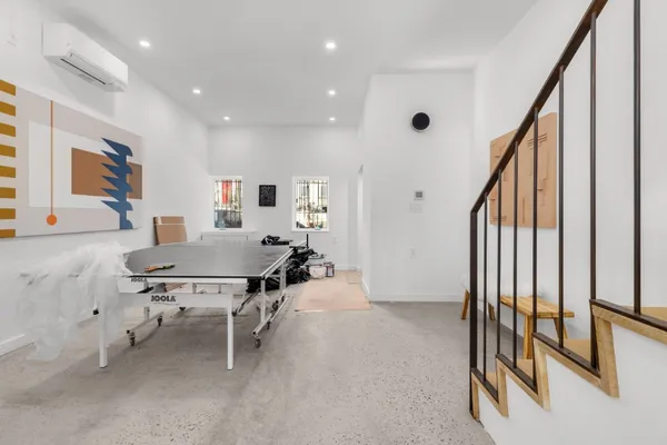 a view of a livingroom with furniture and stairs