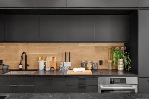 a room with a sink potted plants and floor to ceiling window