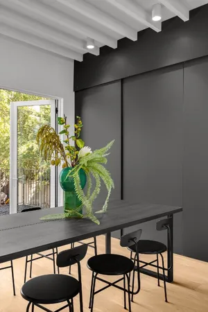 a table room with two chairs and a potted plant